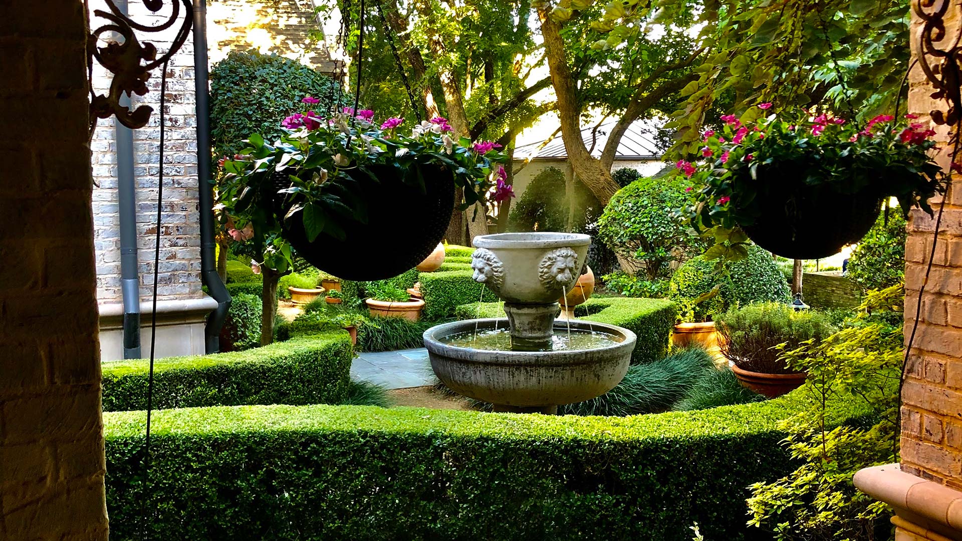 Beautiful landscaping around a fancy fountain at a home in Plano, TX. 