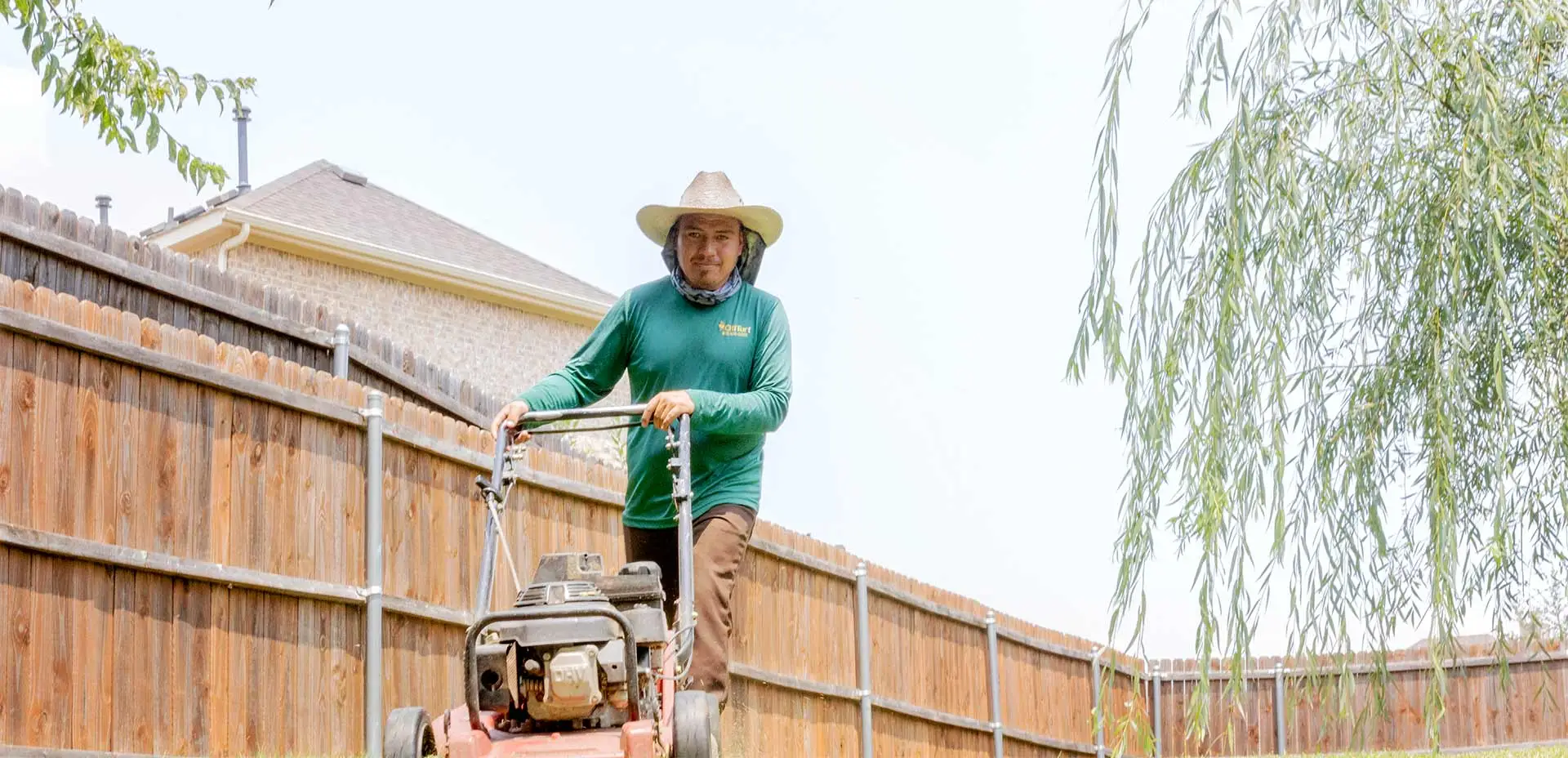 CitiTurf worker mowing a lawn in Plano, TX.