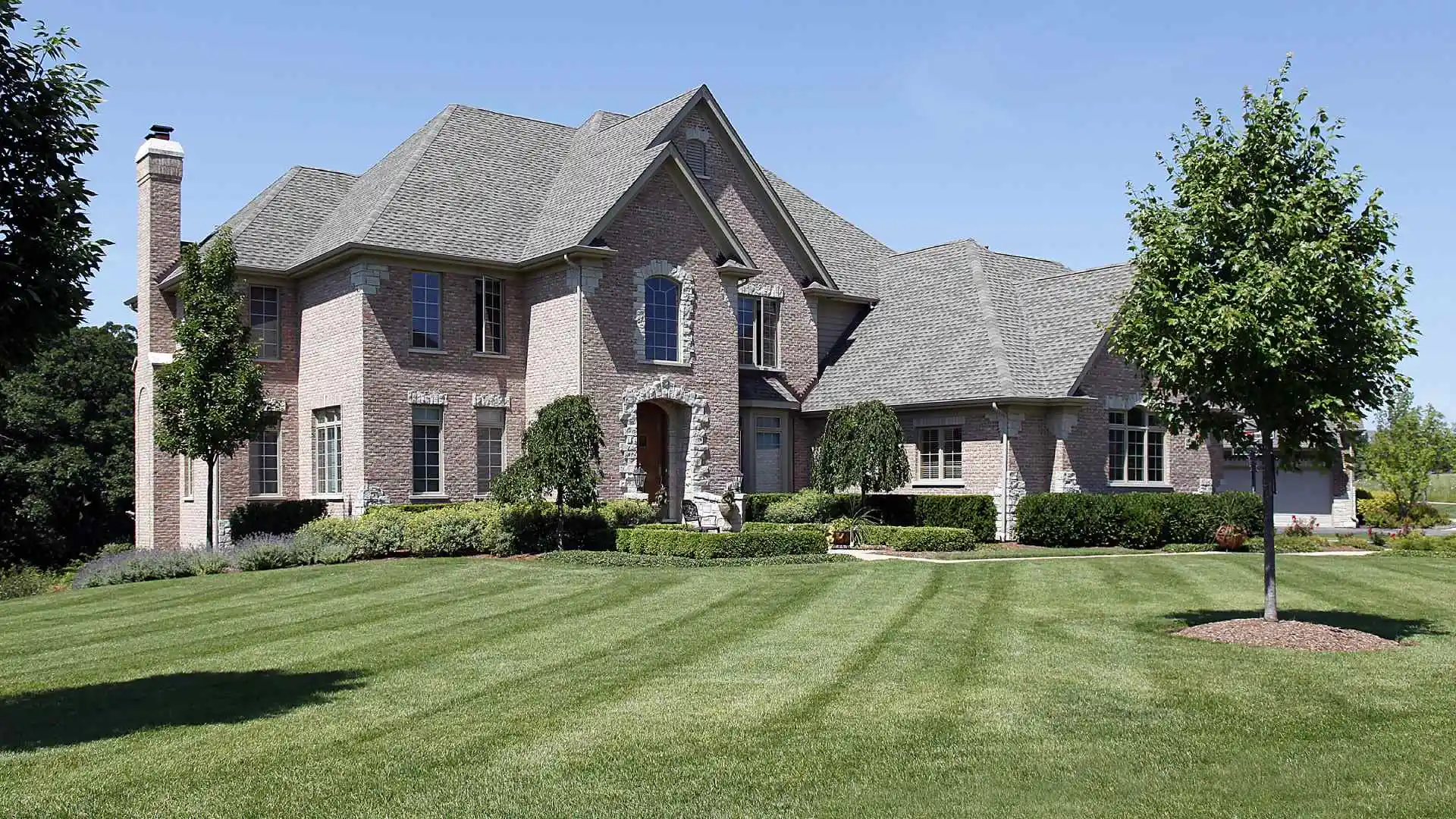 Freshly mowed yard with patterns in front of large home in Wylie, TX.