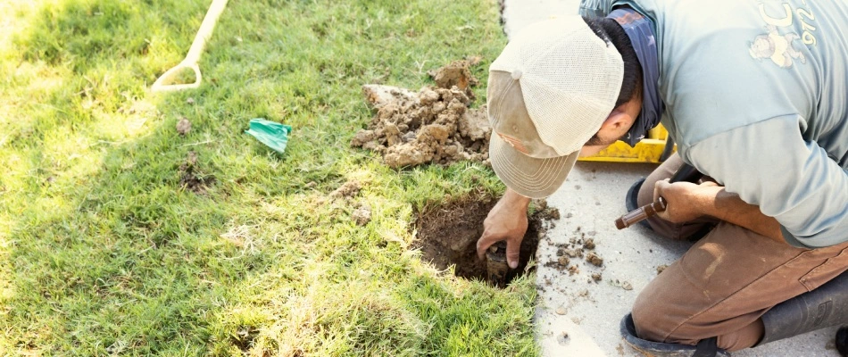 Cititurf professional repairing broken sprinkler in lawn in Sachse, TX.
