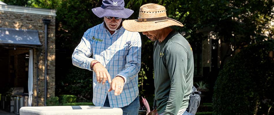 CitiTurf managers discussing landscape maintenance in Frisco, TX.
