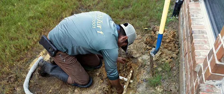 Expert sprinkler and irrigation technician repairing a line in Plano, TX.