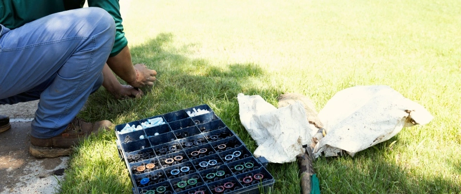 Professional swapping out sprinkler head in lawn in Murphy, TX.