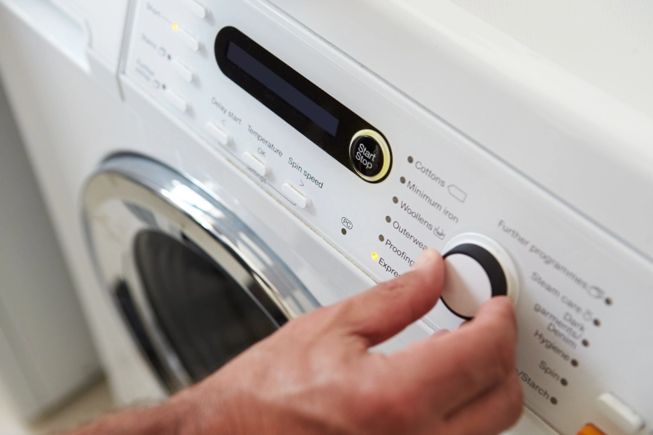 Homeowner washing bedding from bed bug infestation in Frisco, TX.